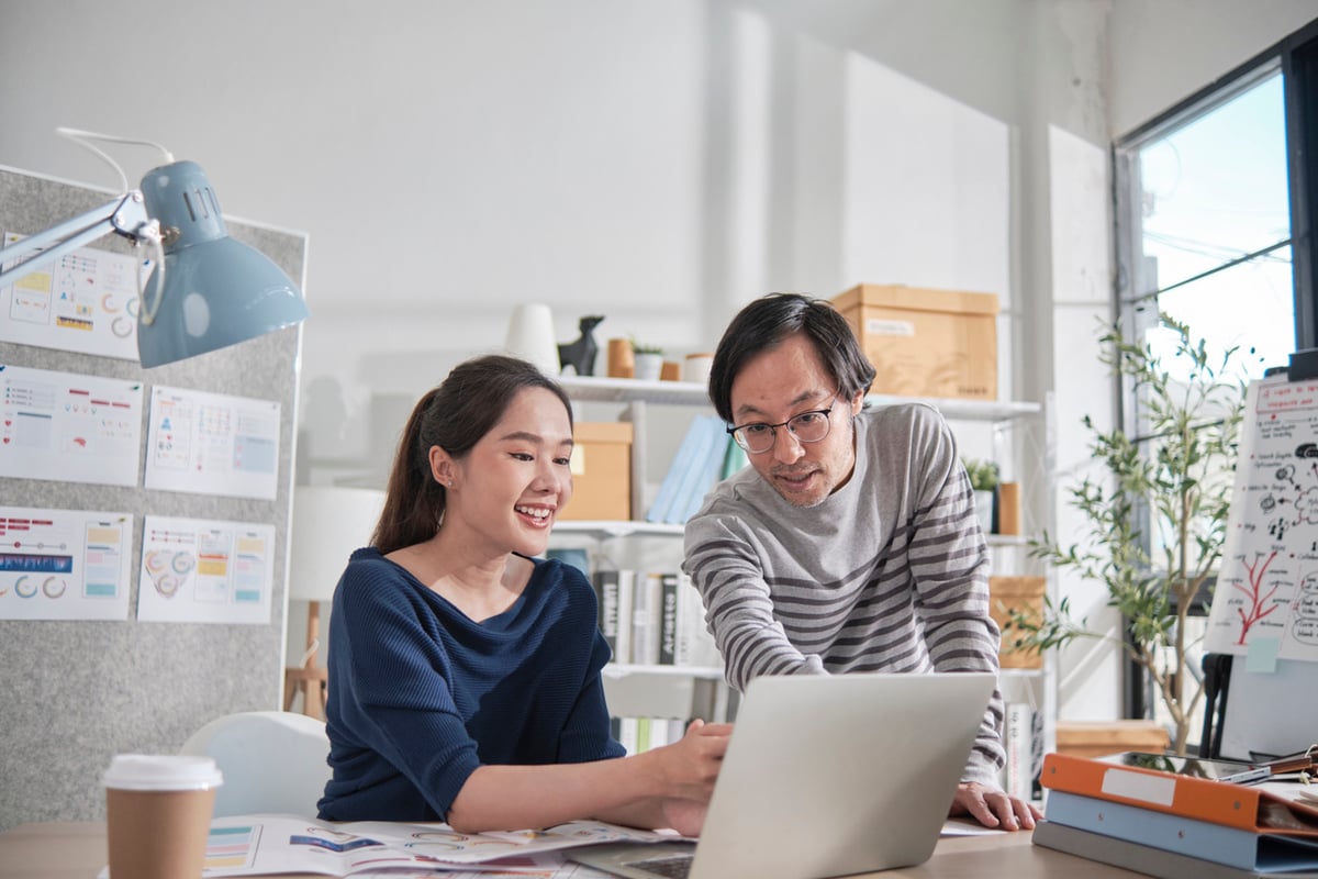 employees collaborating near a computer at work