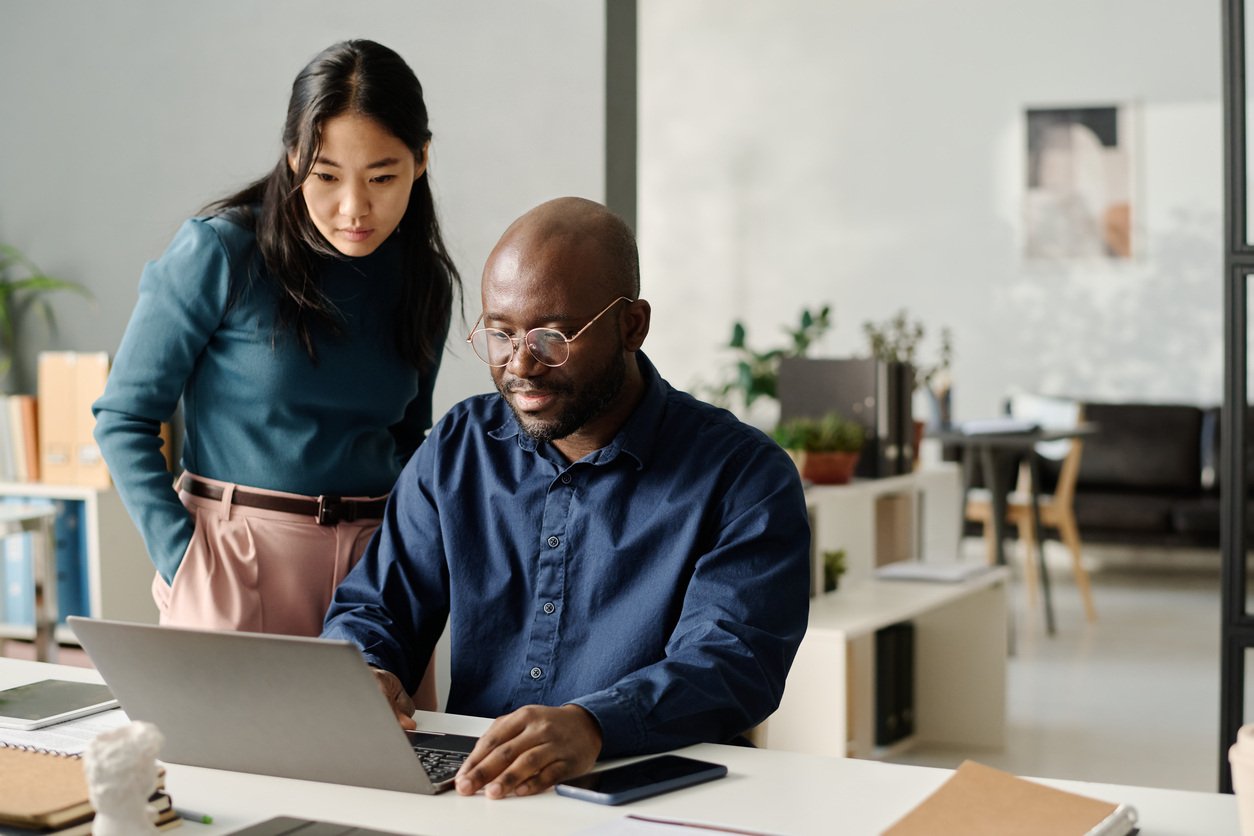 Employees using analytics on a laptop computer