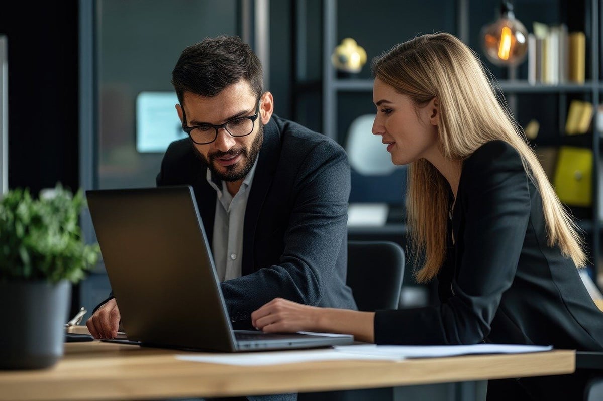 two business professionals looking at data