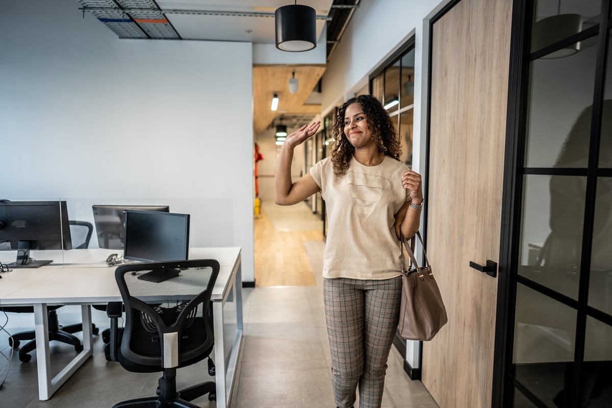 employee waiving goodbye in the workplace