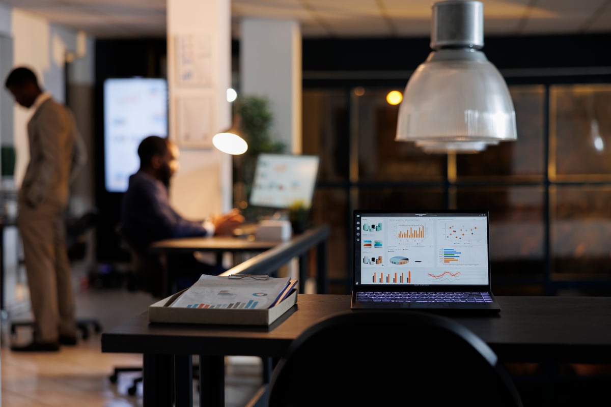 empty desk with a computer showing metrics