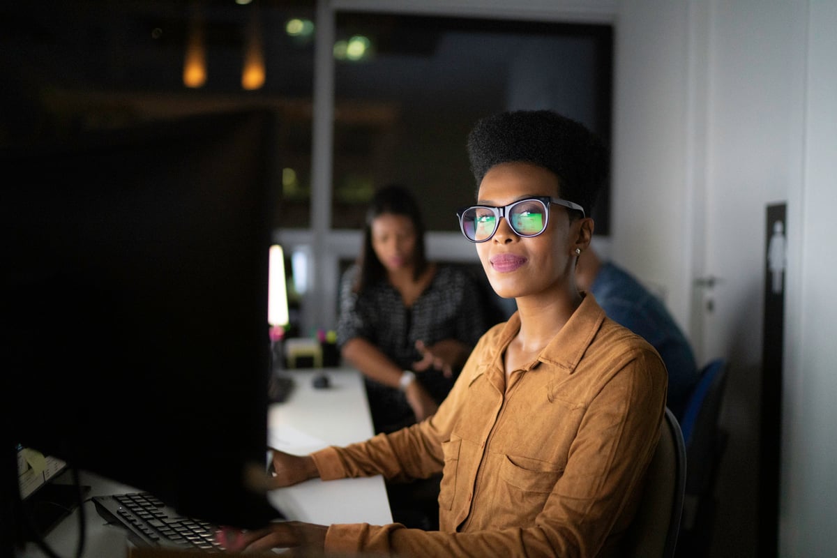 management employee at computer at the office working late