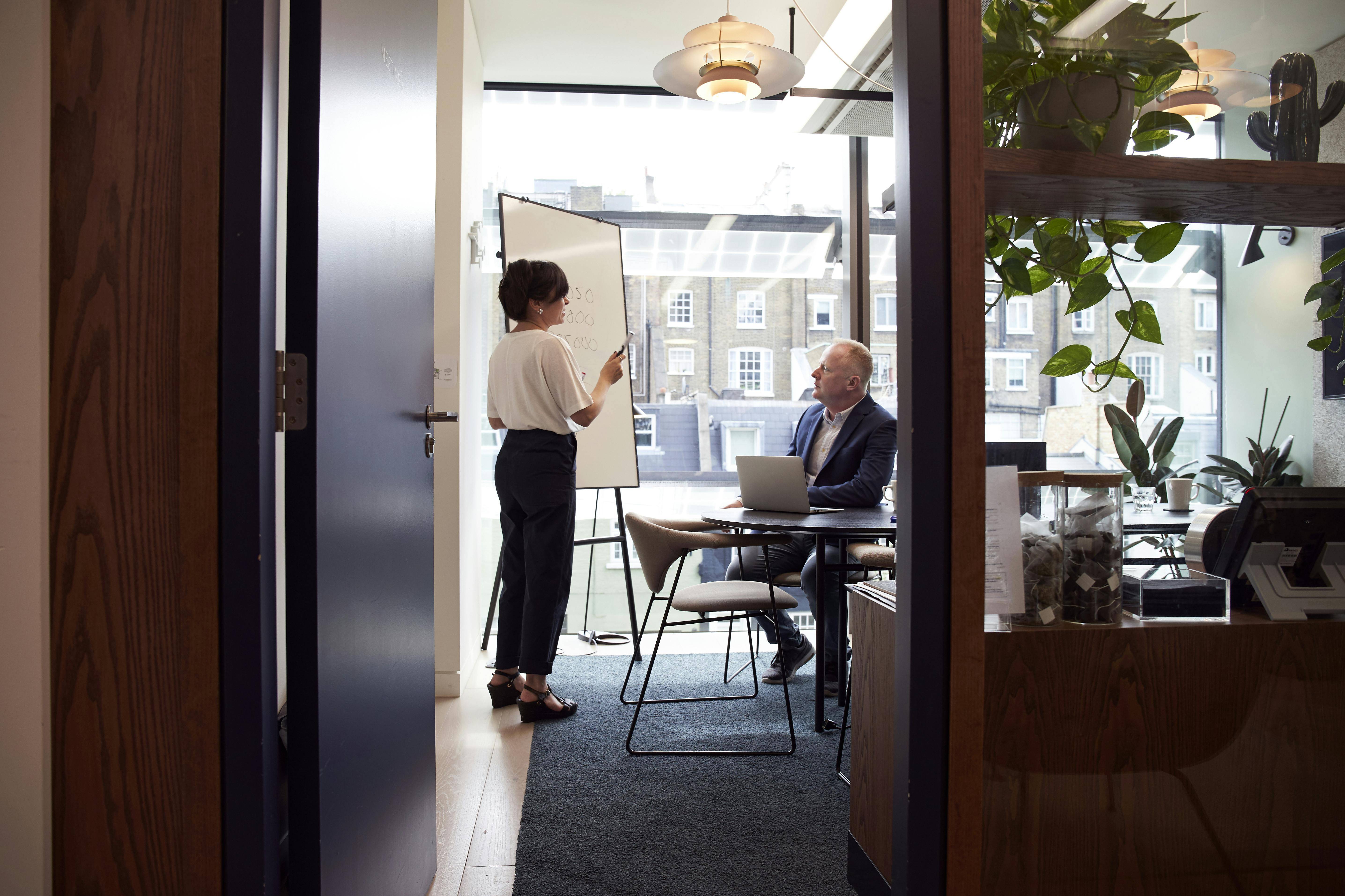 woman presenting metrics in executive meeting