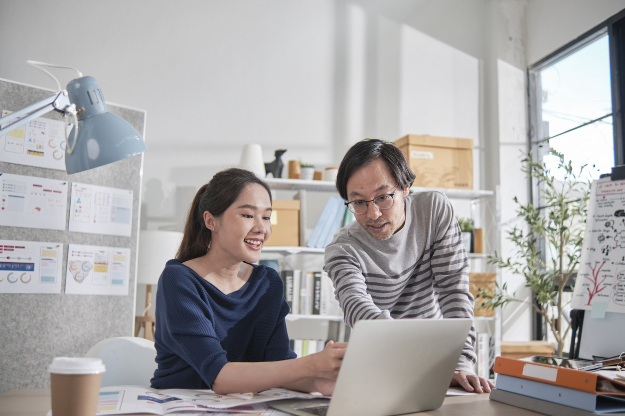 employees collaborating near a computer at work