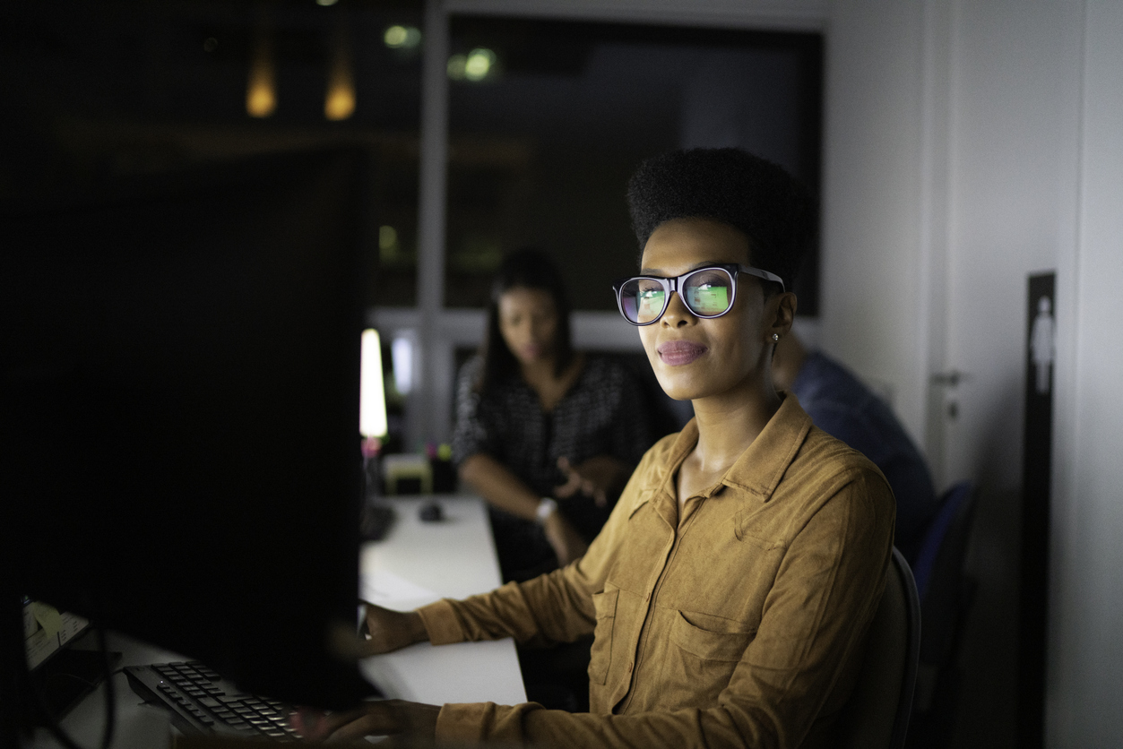 management employee at computer at the office working late